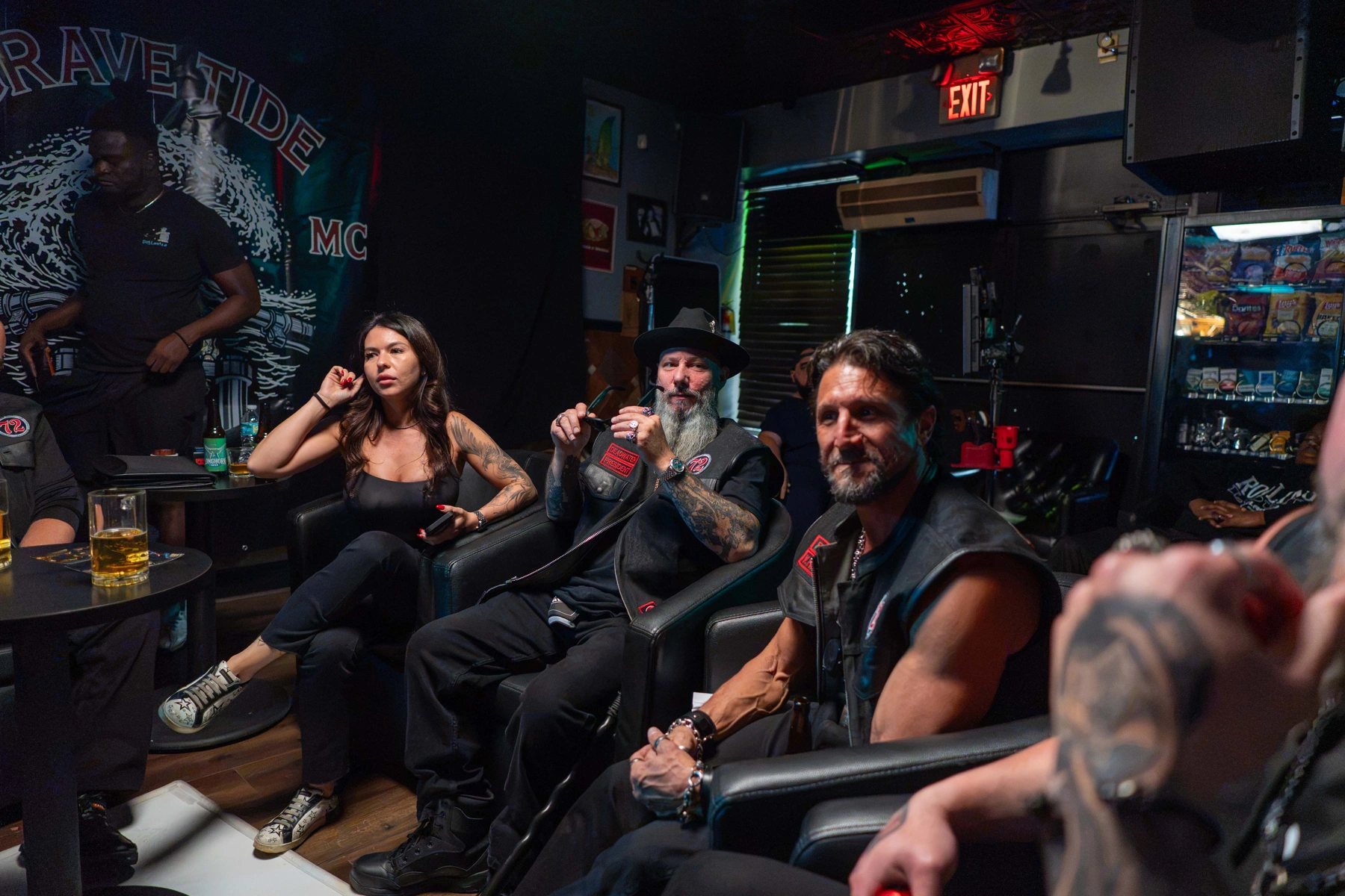 MobKing cast gathered on set in a neon-lit lounge